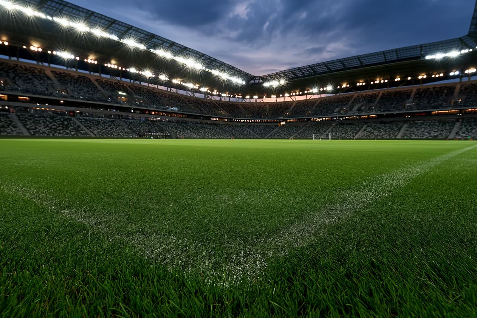 Osvijetljeni nogometni stadion u sumrak prije večernje utakmice.